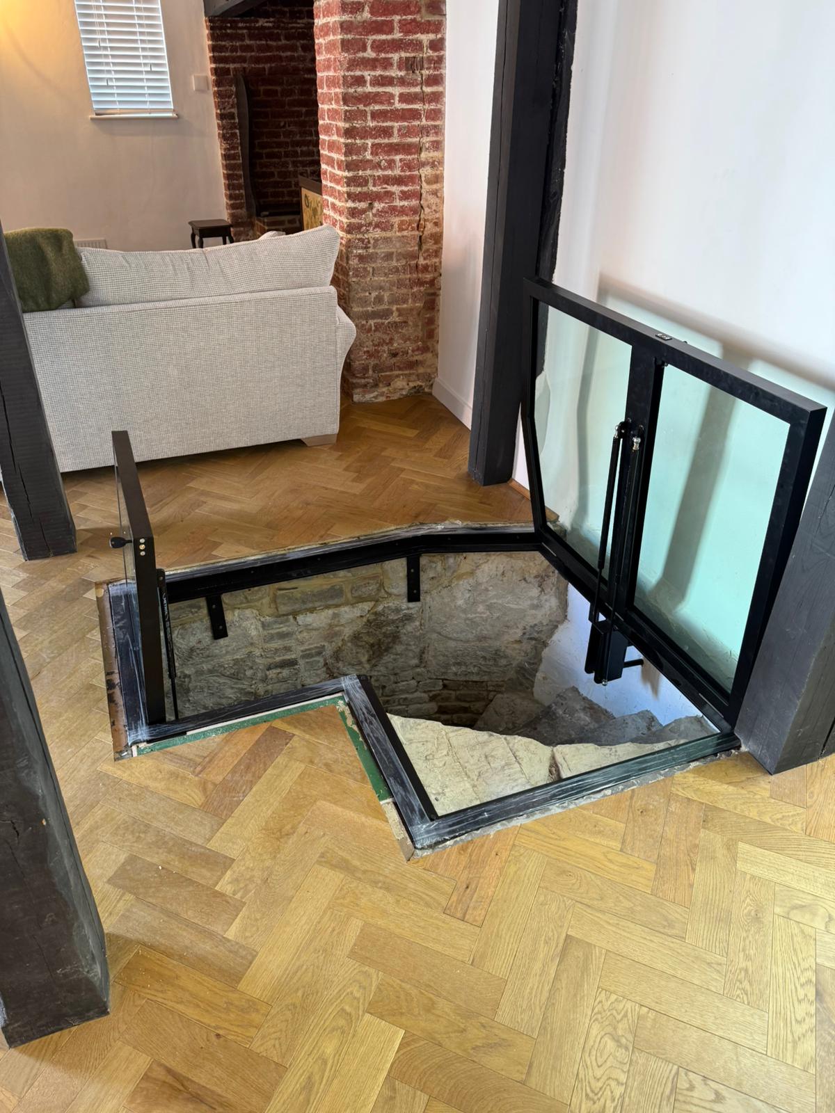 Hinged glass double doors fully open, exposed brick and timber frame, period property Burwash East Sussex